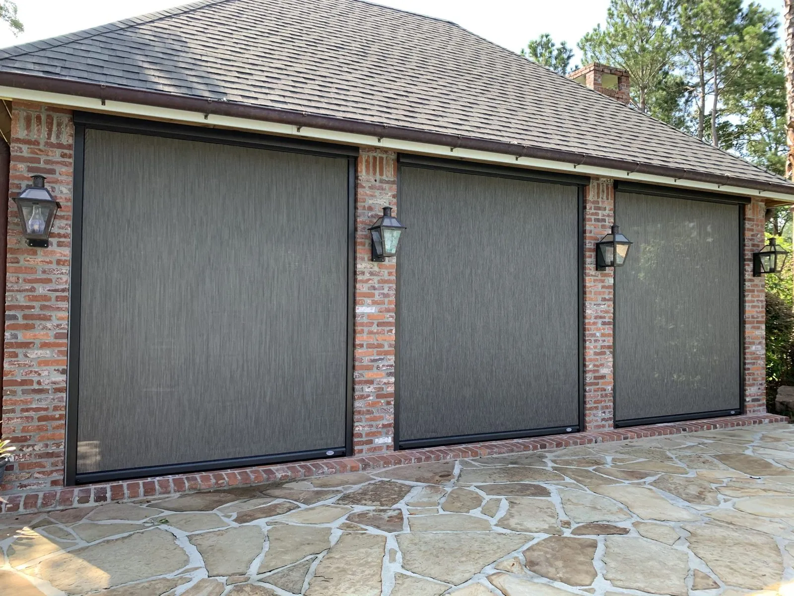 Solar screens lowering over a waterfront covered porch